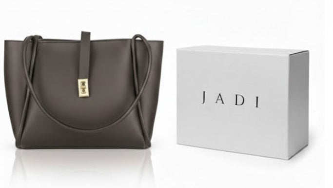 Brown handbag and gray handbag with matching JADI boxes on a white background